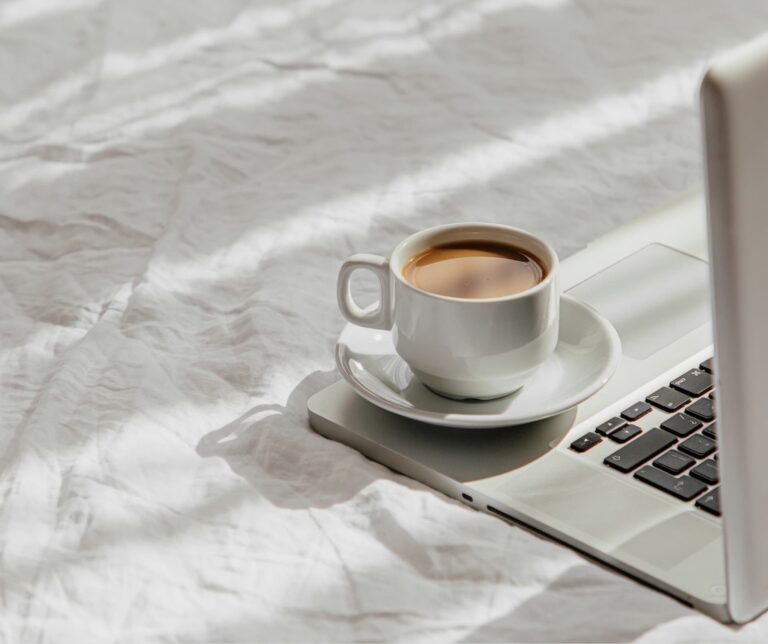 laptop-cup-coffee-white-bed-work-home-concept-morning-light